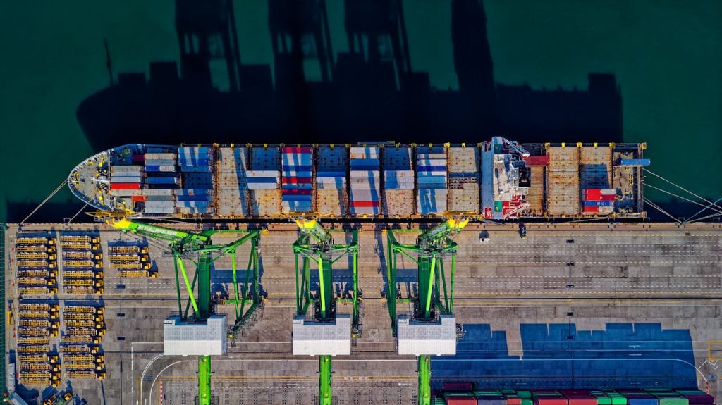 pexels-photo-1554646 High angle aerial view of a cargo ship at a bustling port in Jakarta, showcasing global trade.